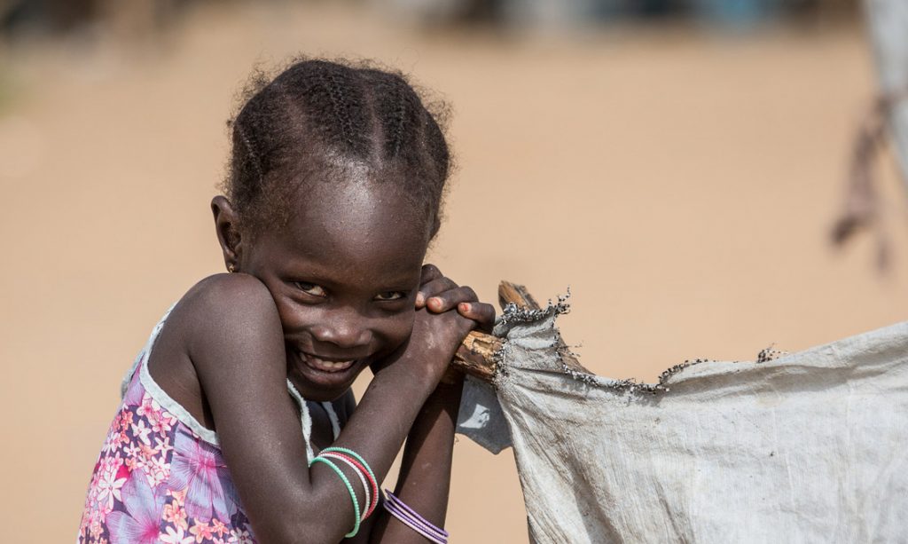 5 August 2016 - Daresalam refugee camp, Chadís Lac Region. Khadija's sister stands in front of the family shelter. The forced journey of Khadija, a refugee in Chad Written by Badre Bahaji Listening to the story of Khadija, 15, and her many travels, I could imagine the dangerous road that these migrant children have taken. In 5 years, "Khadi" as her friends call her, has lived in five different places because of conflict or drought. Khadija Kaku lives in the Daresalam refugee camp in Chadís Lac Region. "My father is a farmer, he left us to go to work a plot of land leased near the shores of the Lake. He doesnít want us to live on humanitarian aid alone," she says, proudly. Kaku Khadija was born in Ariboye, a remote village in north-eastern Nigeria with no school and no clean drinking water. Her parents rented a small piece of land to work, but it wasnít enough. "In 2010, there was another drought. We couldnít harvest enough to live on for the rest of the year. We had to leave our home to travel to the village of Meltri on the shores of Lake Chad. Our uncle welcomed us there," she continues. The life of a teenager Khadijaís life in Meltri looks like the life of the kind of teenager I know. "My uncle had a television, a computer and a small shop where he charged peopleís phones. This is where I developed a passion for new technologies. We watched Bollywood shows and music videos from all over Africa. Then weíd go out with friends and try to imitate the movies or the lyrics for fun,î she says with an embarrassed smile. It was also in Meltri where Khadija discovered school, quickly advancing to grade 5. Reality would soon catch up to her however. "One morning when we entered the classroom, we found a letter slipped under the door of the school at night, written in Hausa by Boko Haram. The letter ordered parents to send their children home, and teachers to leave the area." The tone of her voice changed immediately as she recounted the incident. I