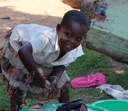 Petite fille effectuant des taches domestiques en Ouganda en 2016 - Crédit photo Thierry Barbaut
